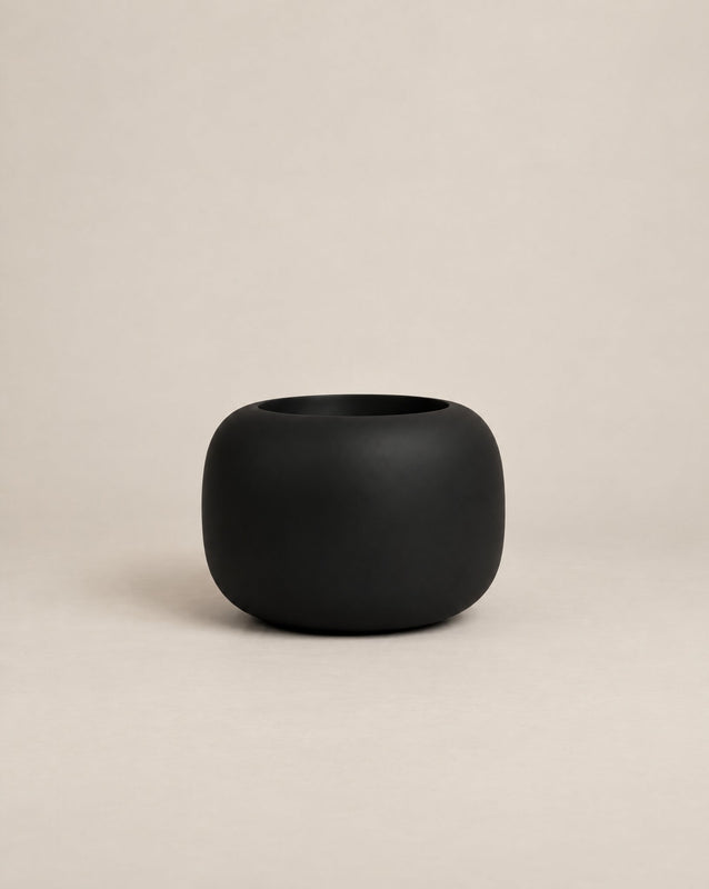 Durum Low black outdoor planter with a compact, rounded shape