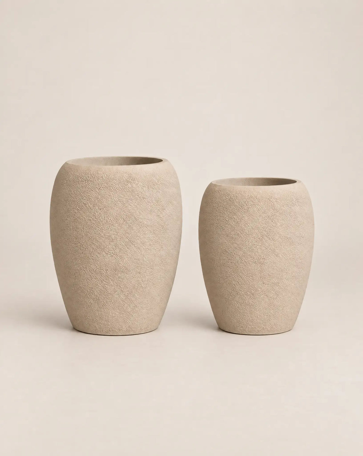 Korby Tall rough-textured putty-finish outdoor planter with a tall, tapered barrel shape