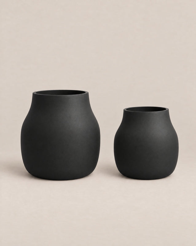 Padina black outdoor planter with a curved, cinched-waist shape and rounded base