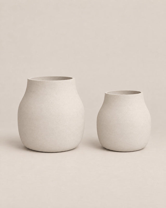 Padina grey outdoor planter with a curved, cinched-waist shape and rounded base