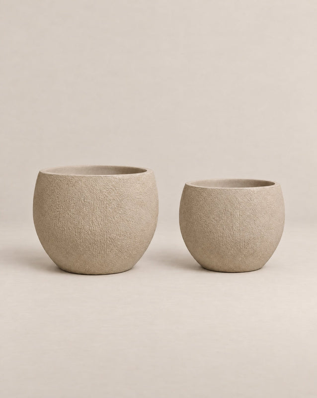Demi Tassina textured putty-finish outdoor planter with straight cylindrical walls and a rounded base