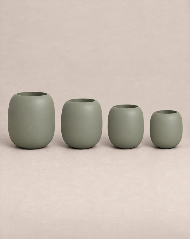 Durum Tall green outdoor planter with a rounded barrel shape and footed base