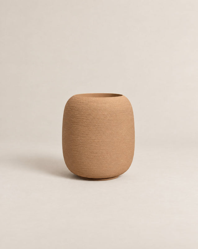 Durum Tall desert stone outdoor planter with a rounded barrel shape and footed base – alternate view