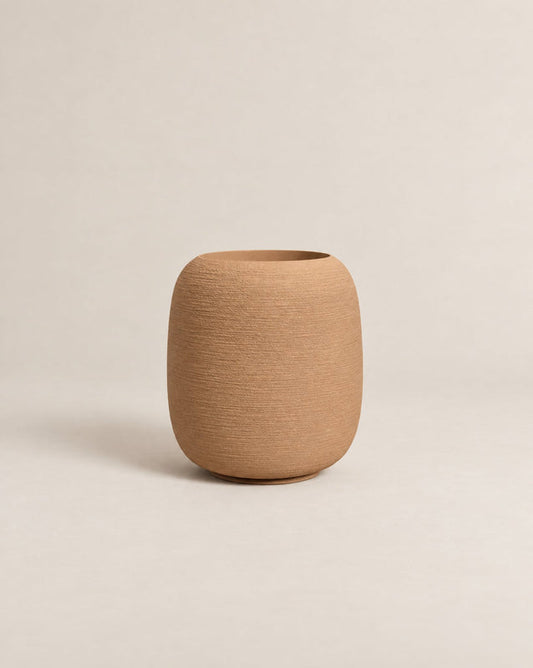 Durum Tall desert stone outdoor planter with a rounded barrel shape and footed base – alternate view