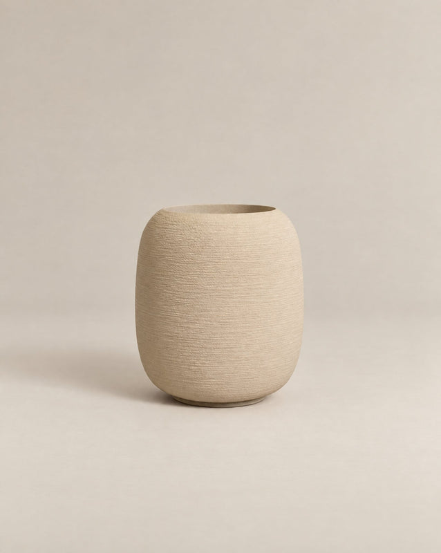 Durum Tall putty stone outdoor planter with a rounded barrel shape and footed base – alternate view