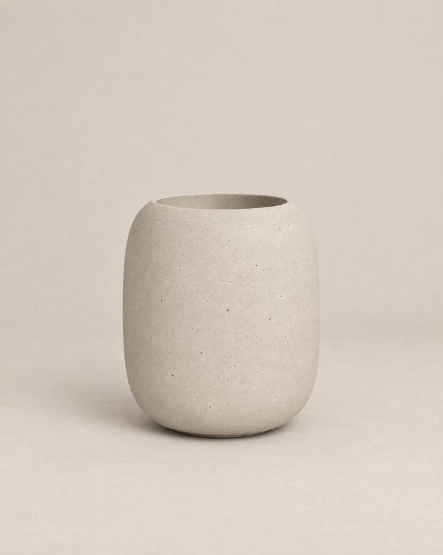 Durum Tall grey outdoor planter with a rounded barrel shape and footed base – alternate view