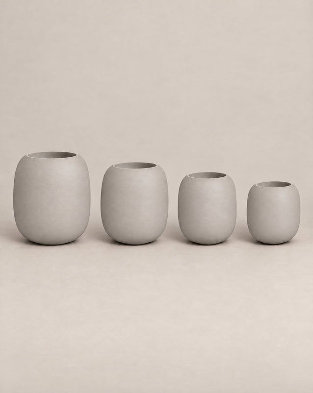 Durum Tall white outdoor planter with a rounded barrel shape and footed base