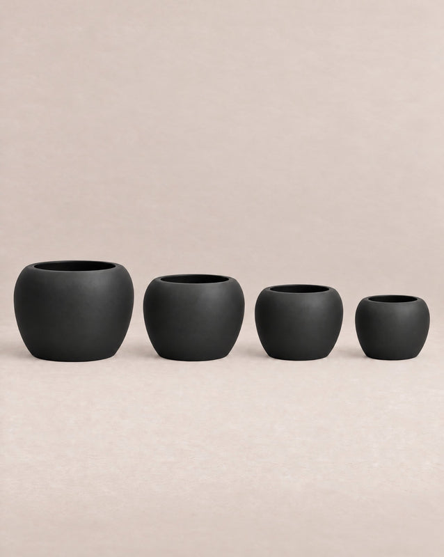 Korby Low black outdoor planter with a low, rounded barrel shape