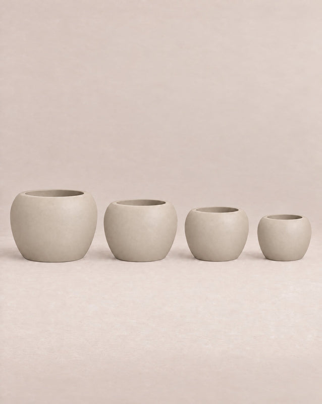 Korby Low grey outdoor planter with a low, rounded barrel shape