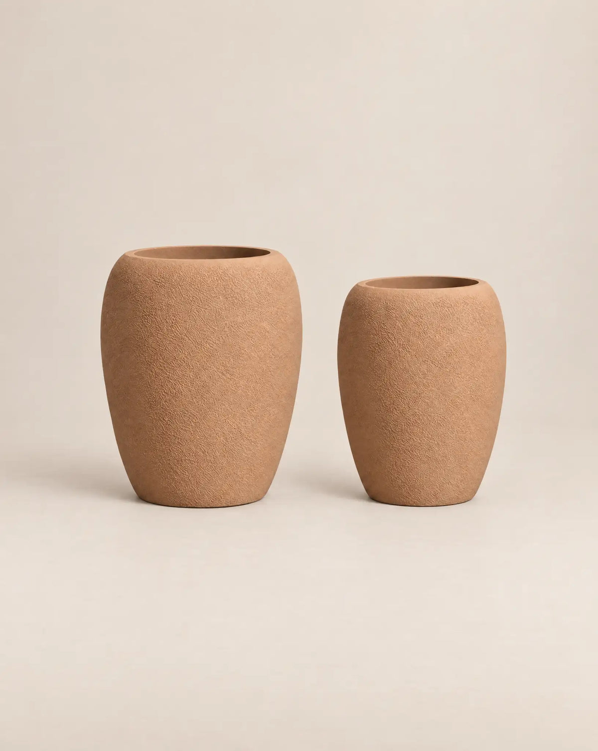 Korby Tall rough-textured desert-finish outdoor planter with a tall, tapered barrel shape