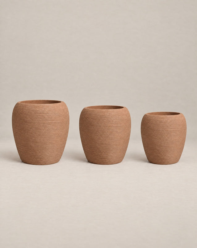 Korby Tall textured desert-finish outdoor planter with a tall, tapered barrel shape