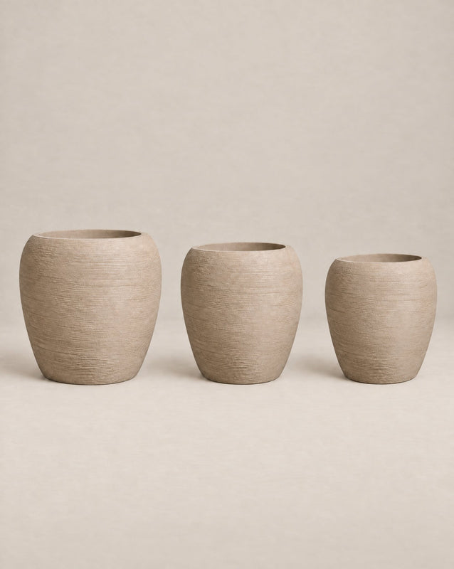 Korby Tall textured putty-finish outdoor planter with a tall, tapered barrel shape