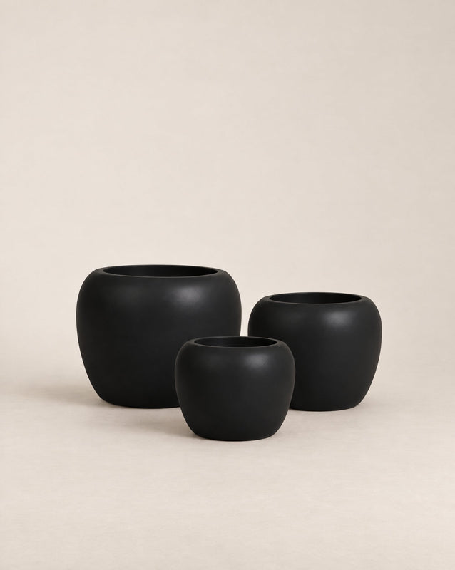 Korby Low black outdoor planter with a low, rounded barrel shape – shown as a trio