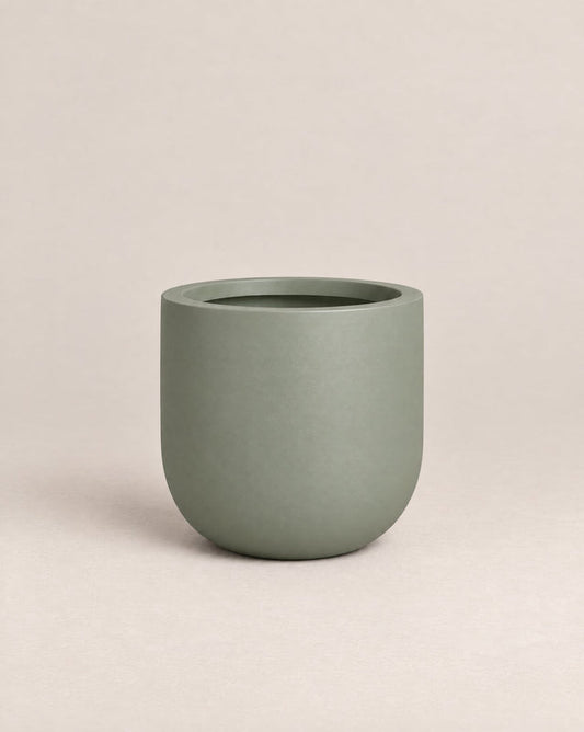 Tassina green outdoor planter with cylindrical walls and a rounded base – alternate view