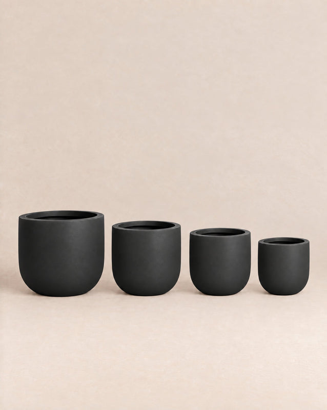 Tassina black outdoor planter with cylindrical walls and a rounded base