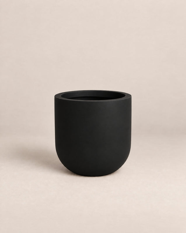 Tassina black outdoor planter with cylindrical walls and a rounded base – alternate view