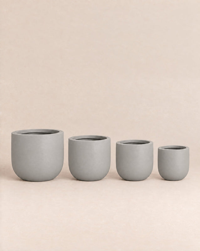Tassina white outdoor planter with cylindrical walls and a rounded base