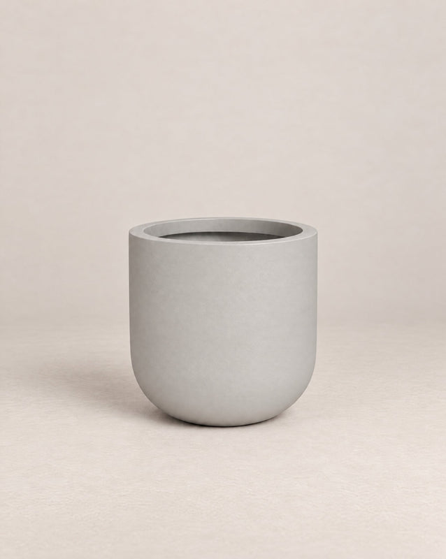 Tassina white outdoor planter with cylindrical walls and a rounded base – alternate view
