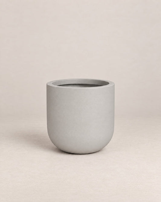 Tassina white outdoor planter with cylindrical walls and a rounded base – alternate view